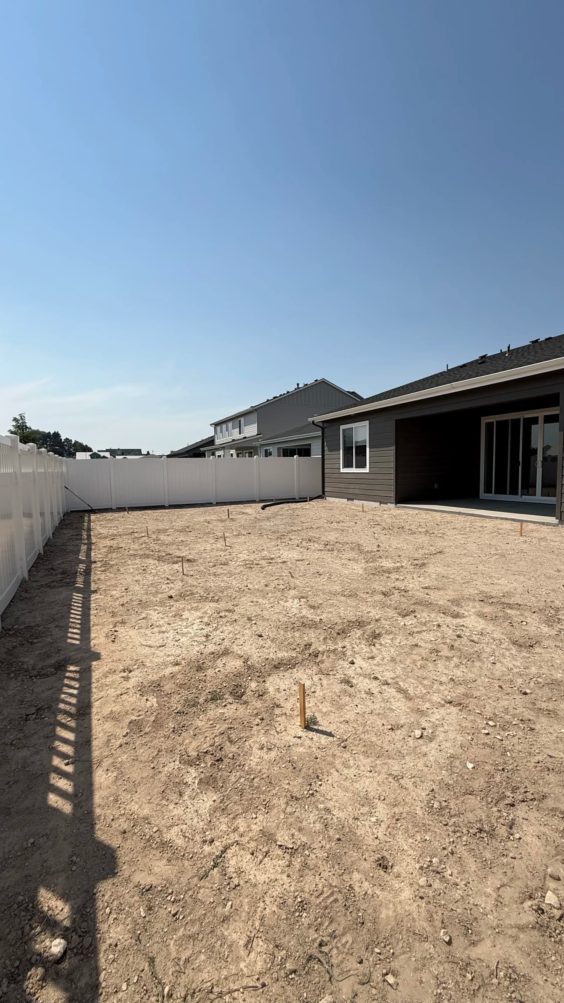 Bare Dirt Backyard Gets a Full Landscape Build with Sod and Fountain image